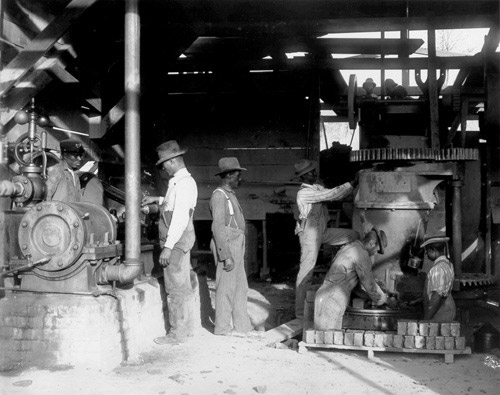 Photograph shows students of the Tuskegee Institute, Tuskegee, making bricks