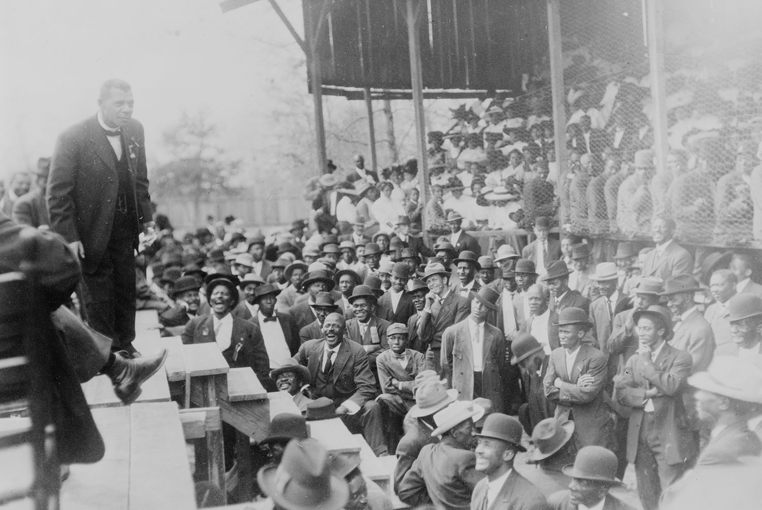 Booker T. Washington standing on a stage before large crowd in Lakeland