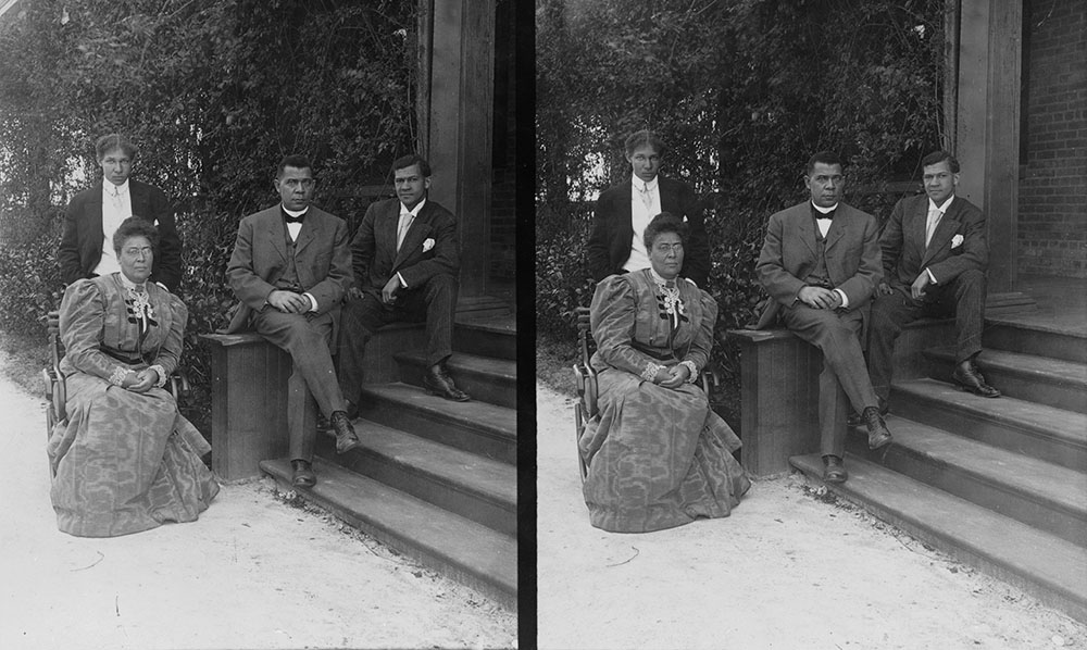 Booker T. Washington, seated on steps of
porch, with wife and two sons]