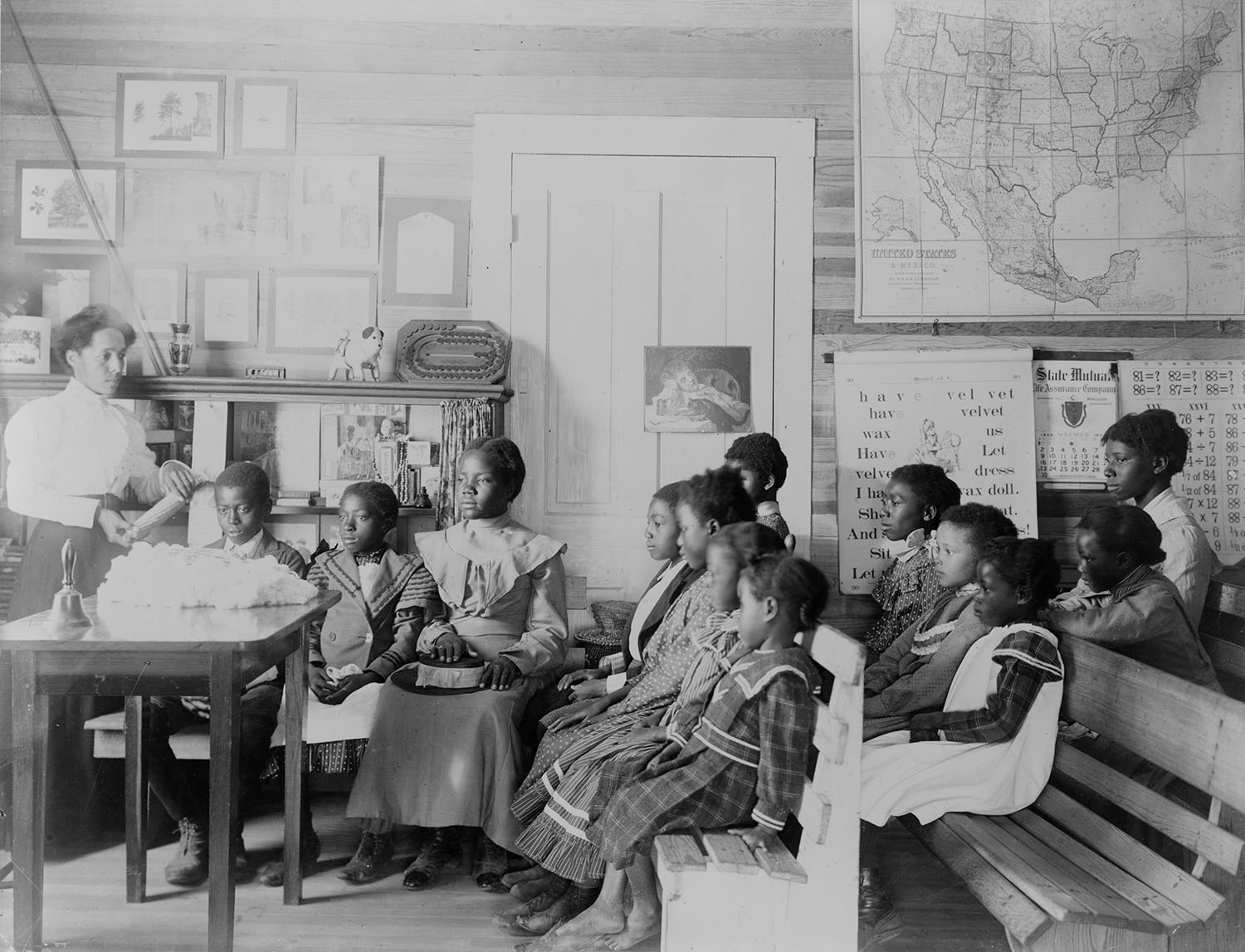 Photograph shows 
Young students in a classroom at the Tuskegee Normal and Industrial Institute
