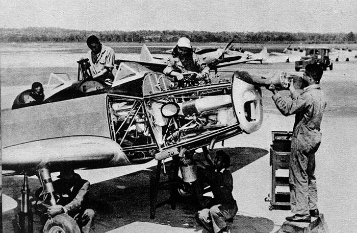 Photograph of A plane crew at work on a 100-hour inspection.