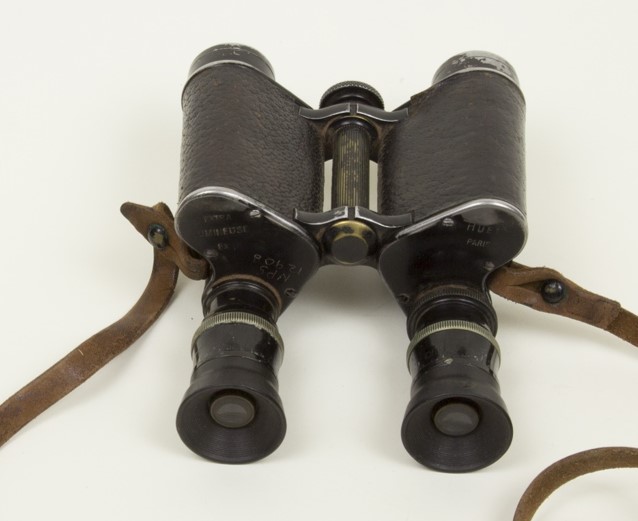 black binoculars with brown leather strap
