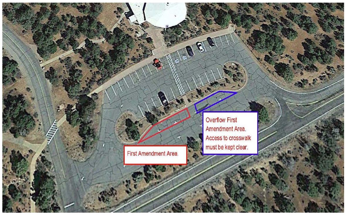 An overhead view of a visitor center and parking lot with the First Amendment area marked