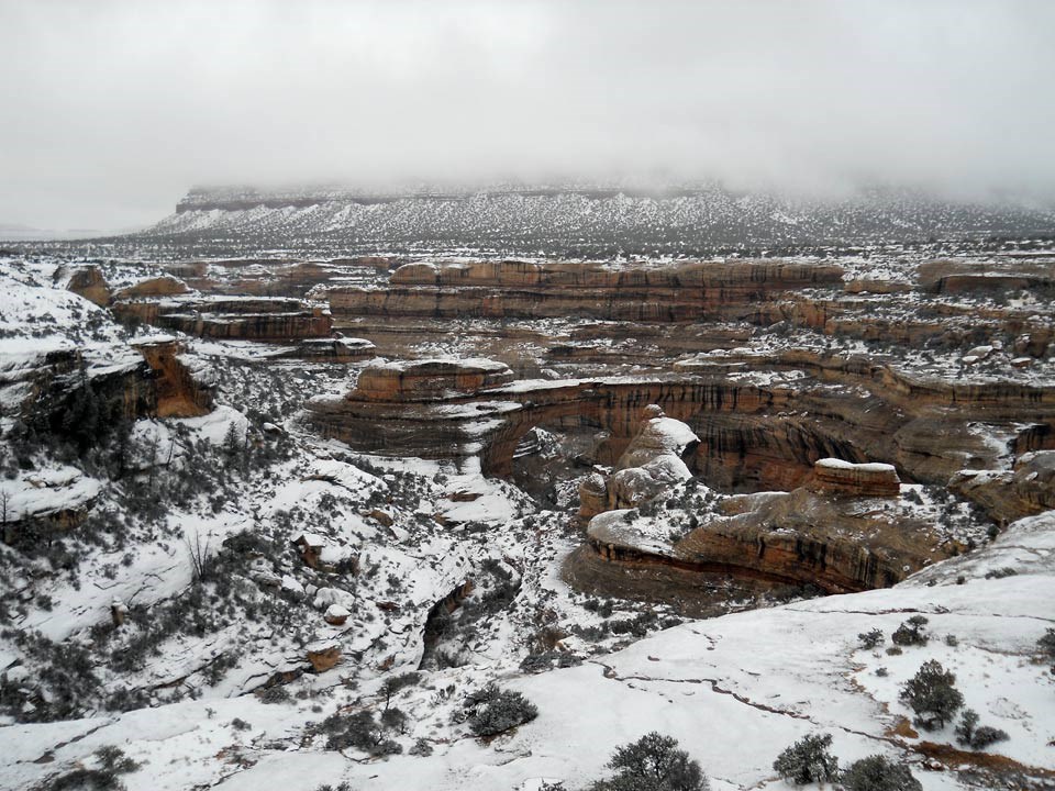 Sipapu Bridge and surrounding canyon covered in snow