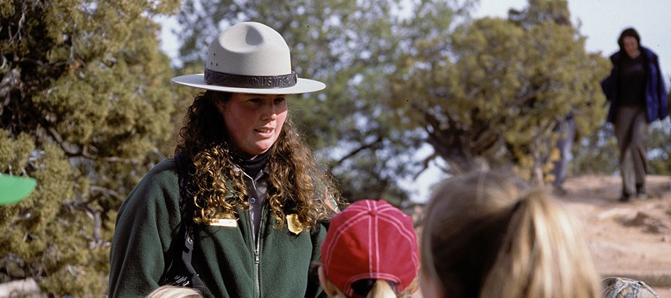 a park ranger speaks to children a park ranger speaks to children