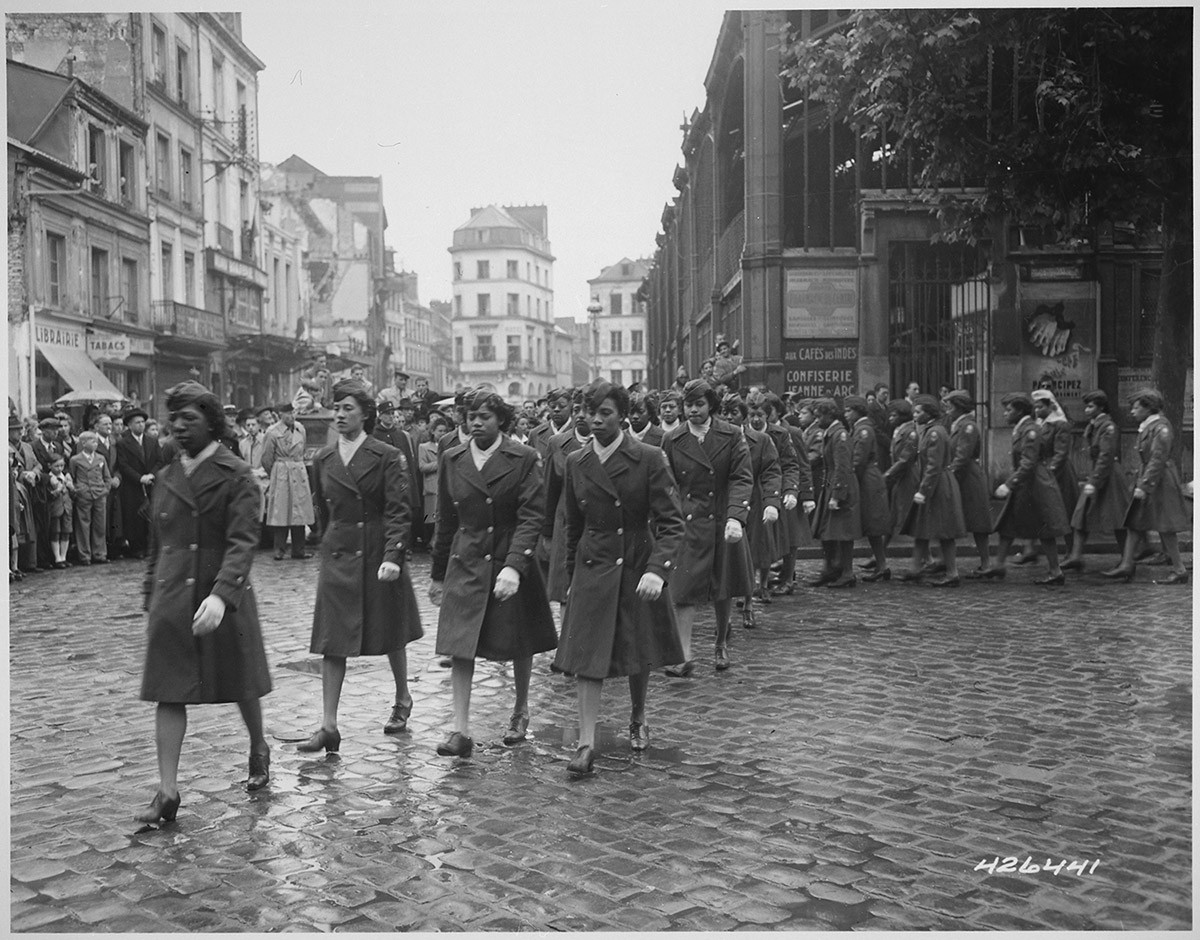 Members of the 6888th Central Postal Directory Battalion walking in formation outside.