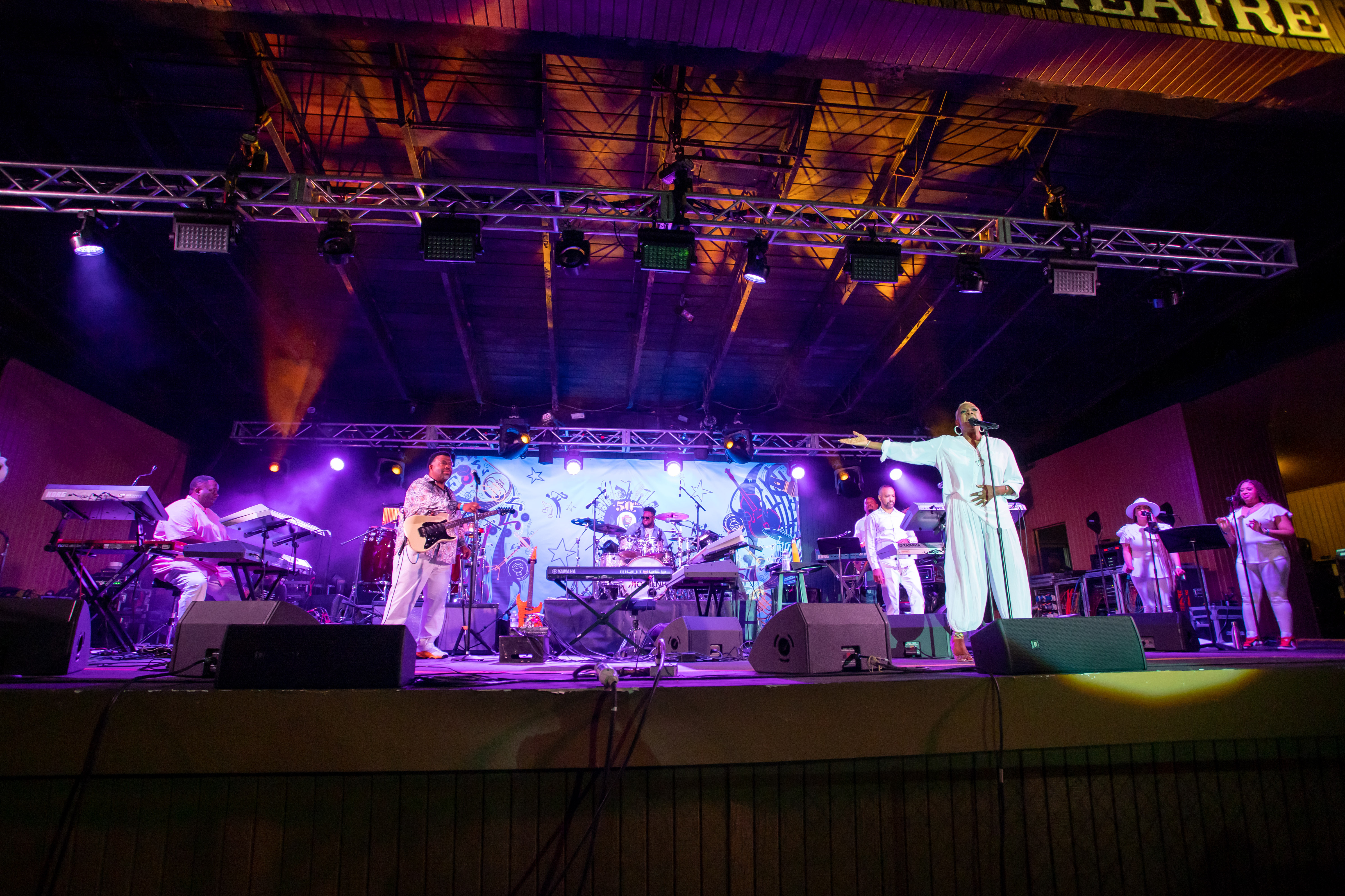 A group performs on an outdoor stage.