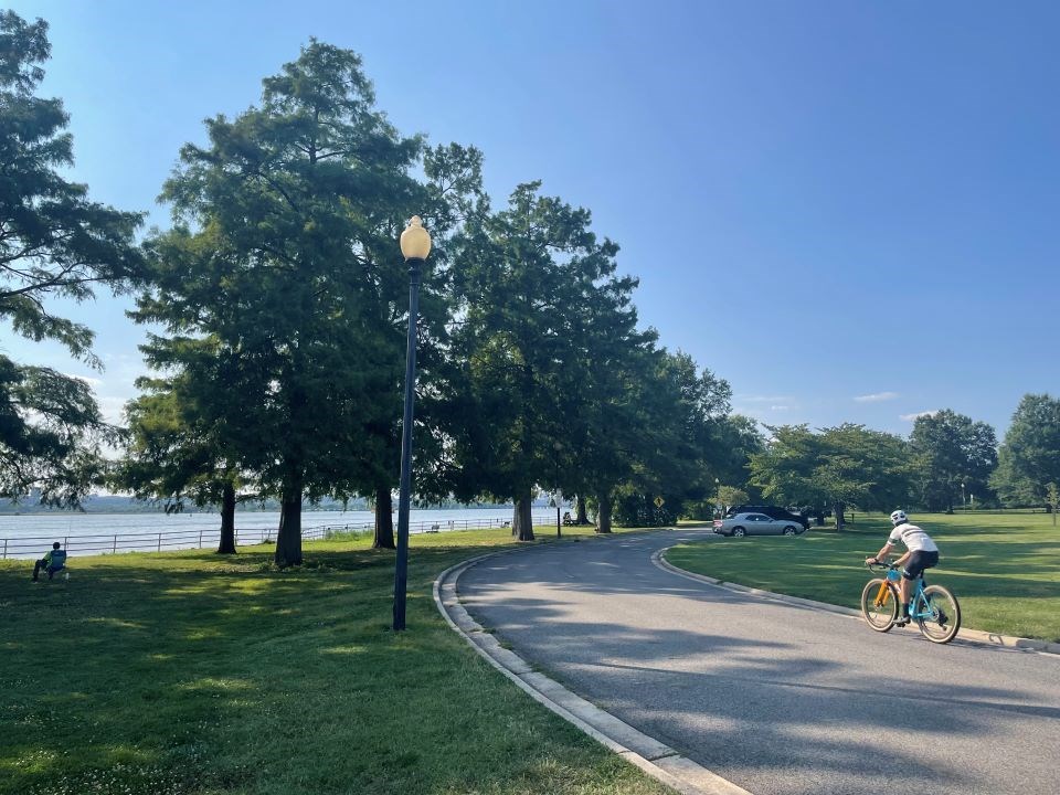 Photo of a bicyclist on a ride with a river to their left