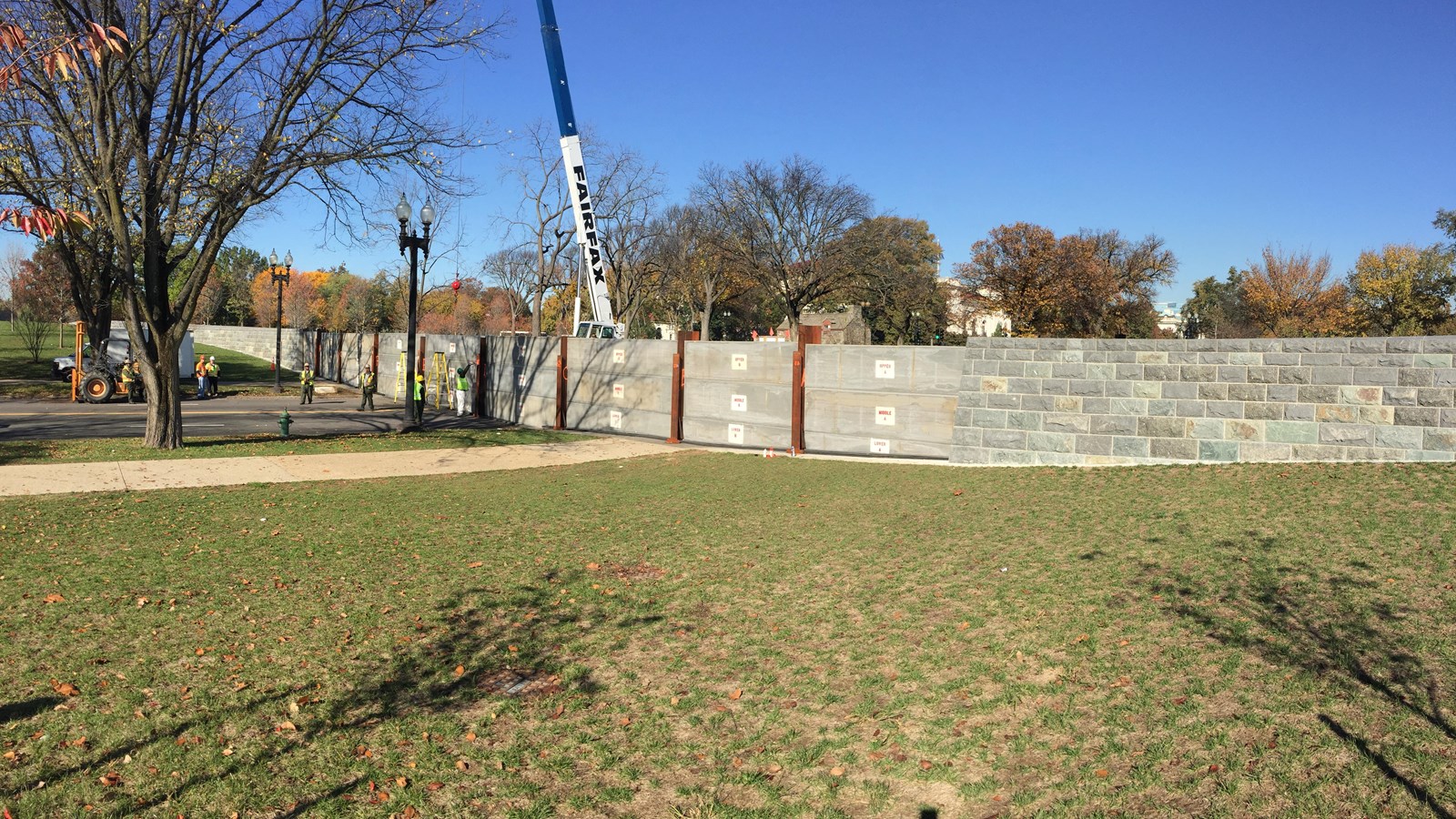 NPS employees install alumnium panels as part of the 17th Street levee