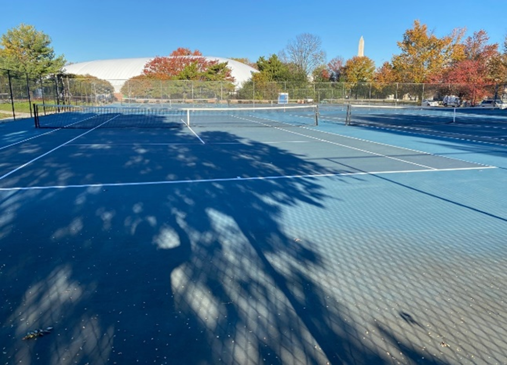 East Potomac Tennis Center Outdoor tennis court with a white dome for an indoor tennis court, and the Washington Monument in the background.