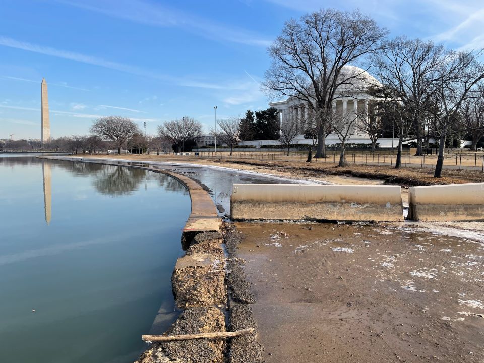 Image of crumbling wall next to flooded trail