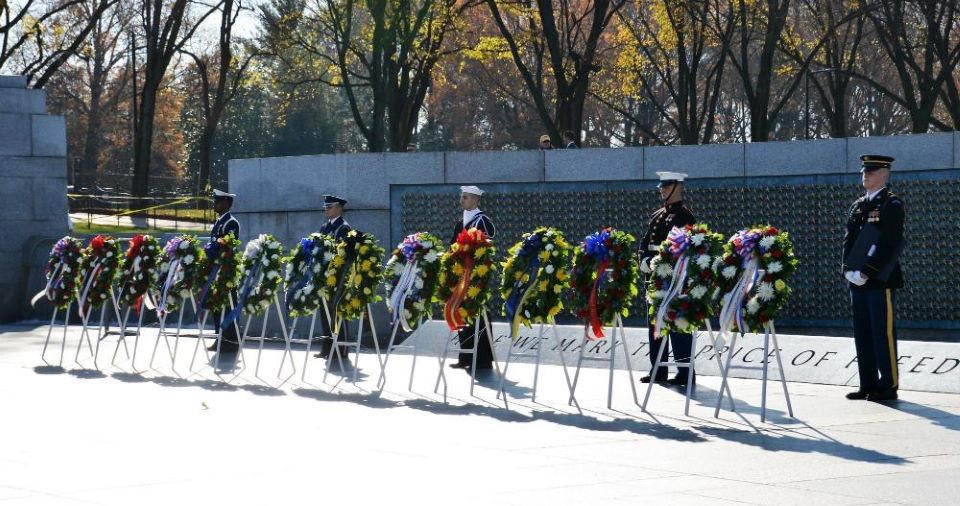 Military service members behind wreaths at the World War II Memorial