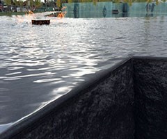 Granite ceremonial flame with water surrounding it and running down the side