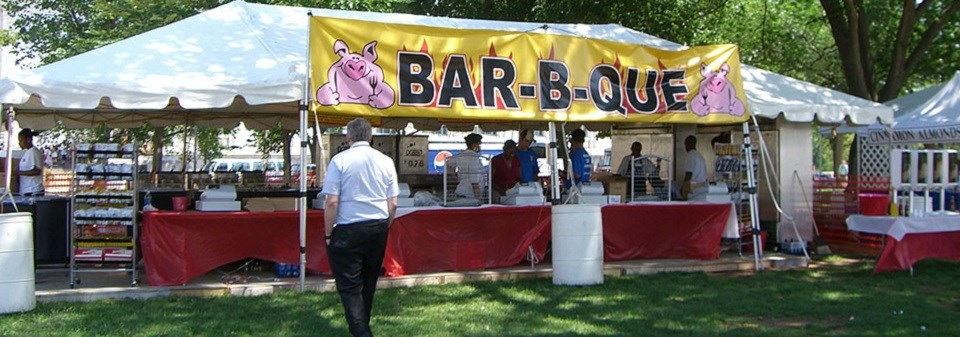 Person approaching a barbeque tent