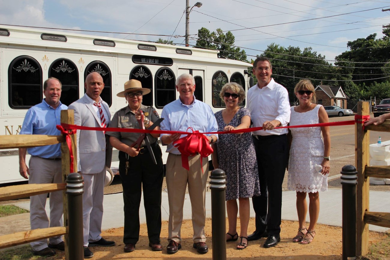 group cutting a ribbon to open Fort Rosalie site in 2016