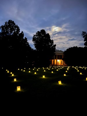 illuminated candles on a hilly lawn