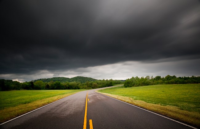 Dark clouds above the Natchez Trace Parkway road way Dark clouds above the Natchez Trace Parkway road way