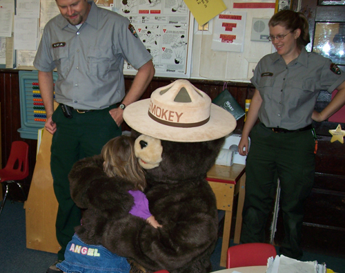 Smokey Bear greets a student in her classroom. Smokey Bear greets a student in her classroom.