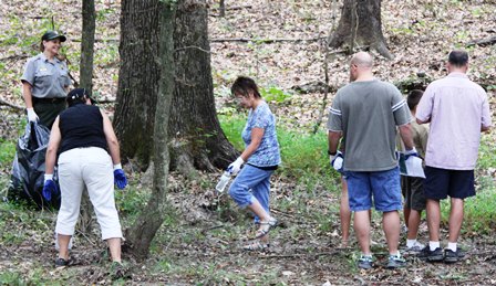 Visitors and Chief of Resource Management, Lisa McInnis remove Japanese stiltgrass