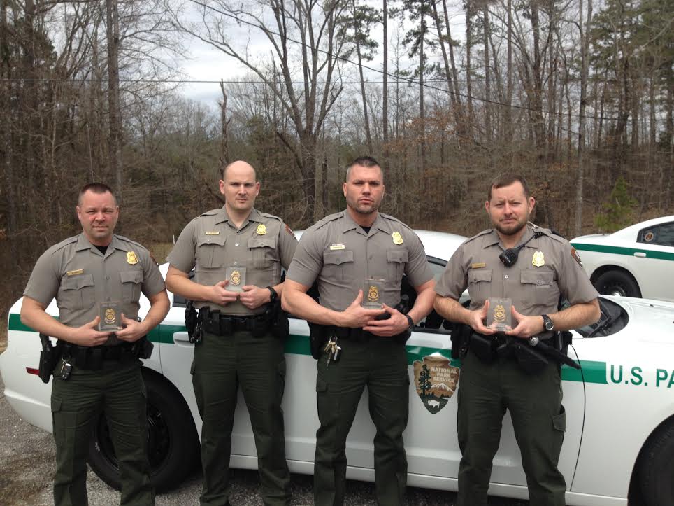 four park rangers holding awards