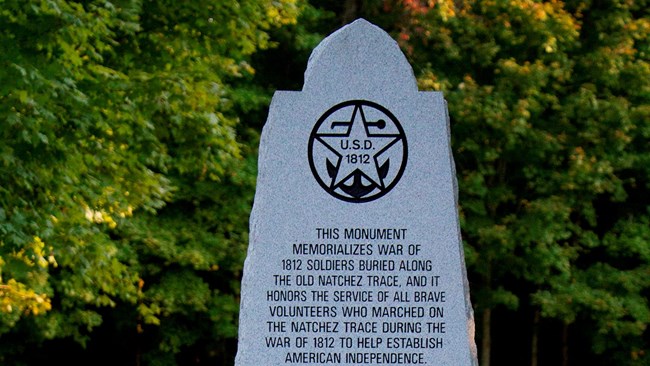 Polished monument with an inscription about the War of 1812.