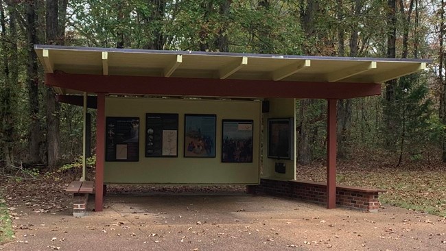 A covered shelter with a few exhibits underneath.