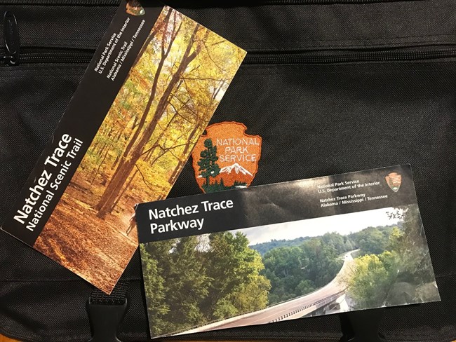 Two map brochures on a backpack.