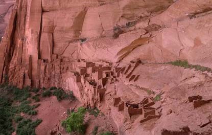 Multi-storied stone houses inside alcove.