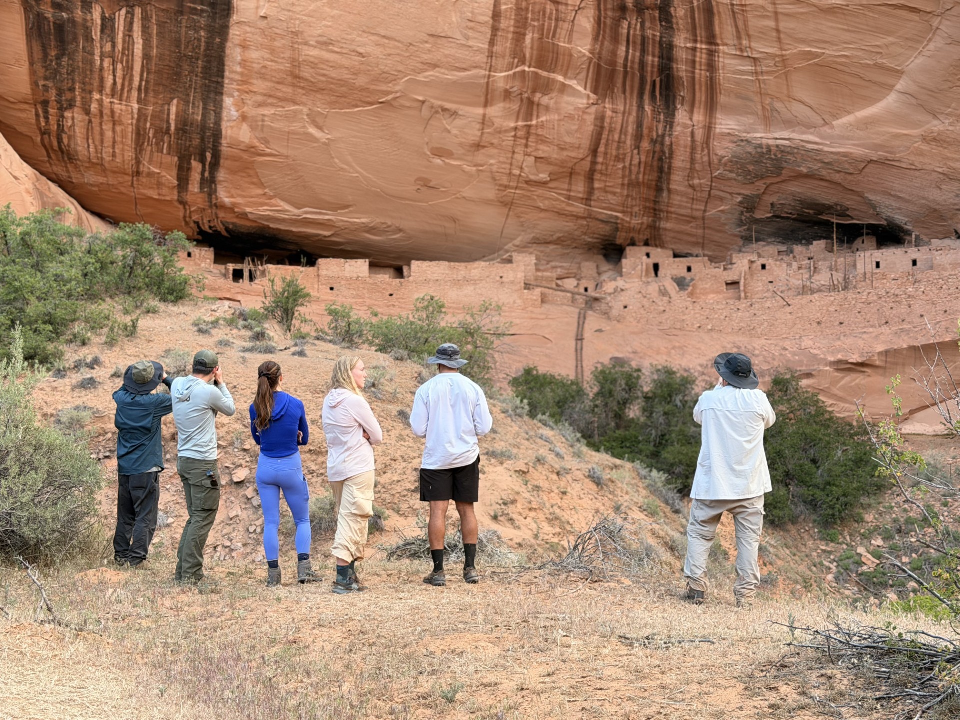 Visitors looking at village sheltered by alcove
