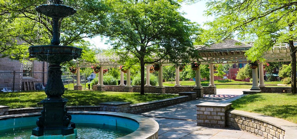 Colorful view with trees and water fountain of the 54th plaza inside Custom House Square