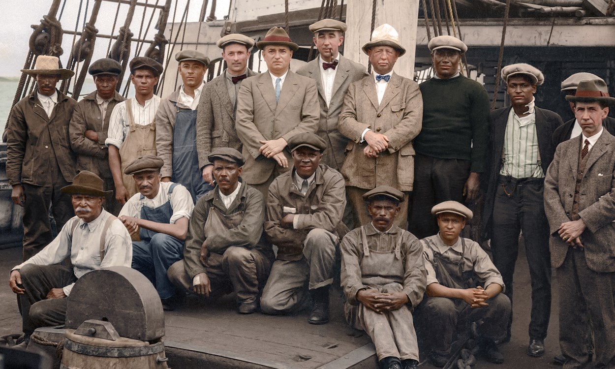 Whaling crew pose aboard ship.