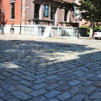 Belgium blocks pattern at the street intersection; NPS building in background.
