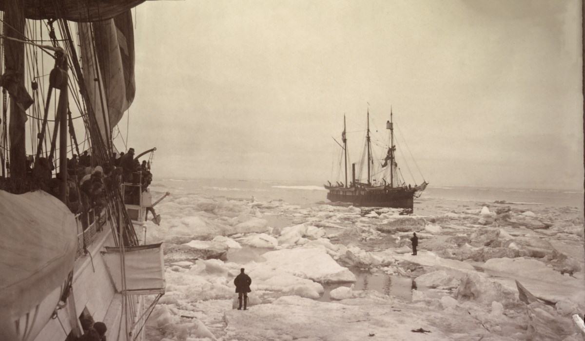 Photo taken from whaling ship shows a ship in the distance of an icy sea.