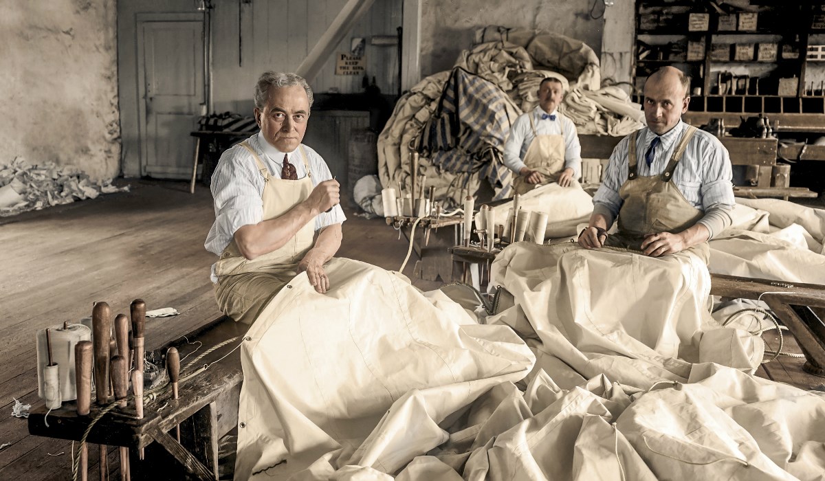 storieslanding page-1200 Colorized image of three men sewing sails during whaling error.