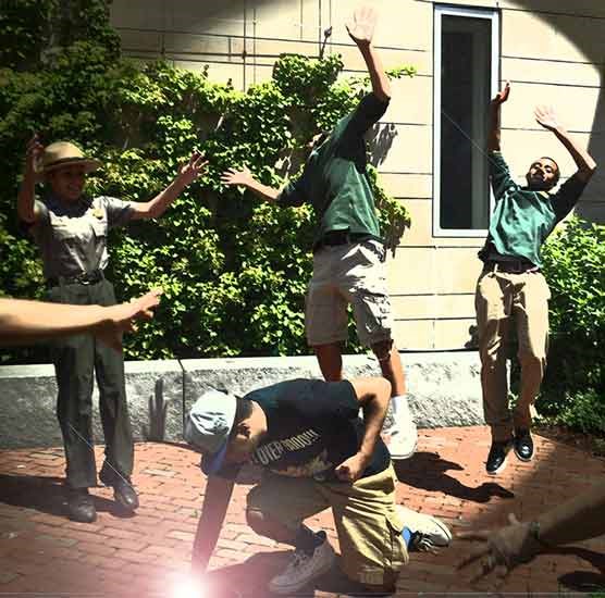 New Bedford community youth are jumping after fellow youth playfully punches the ground like Thor. All have participated in park programs. New Bedford community youth are jumping after fellow youth playfully punches the ground like Thor. All have participated in park programs.