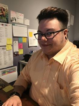 Dan Everton young man with glasses, seated at a desk