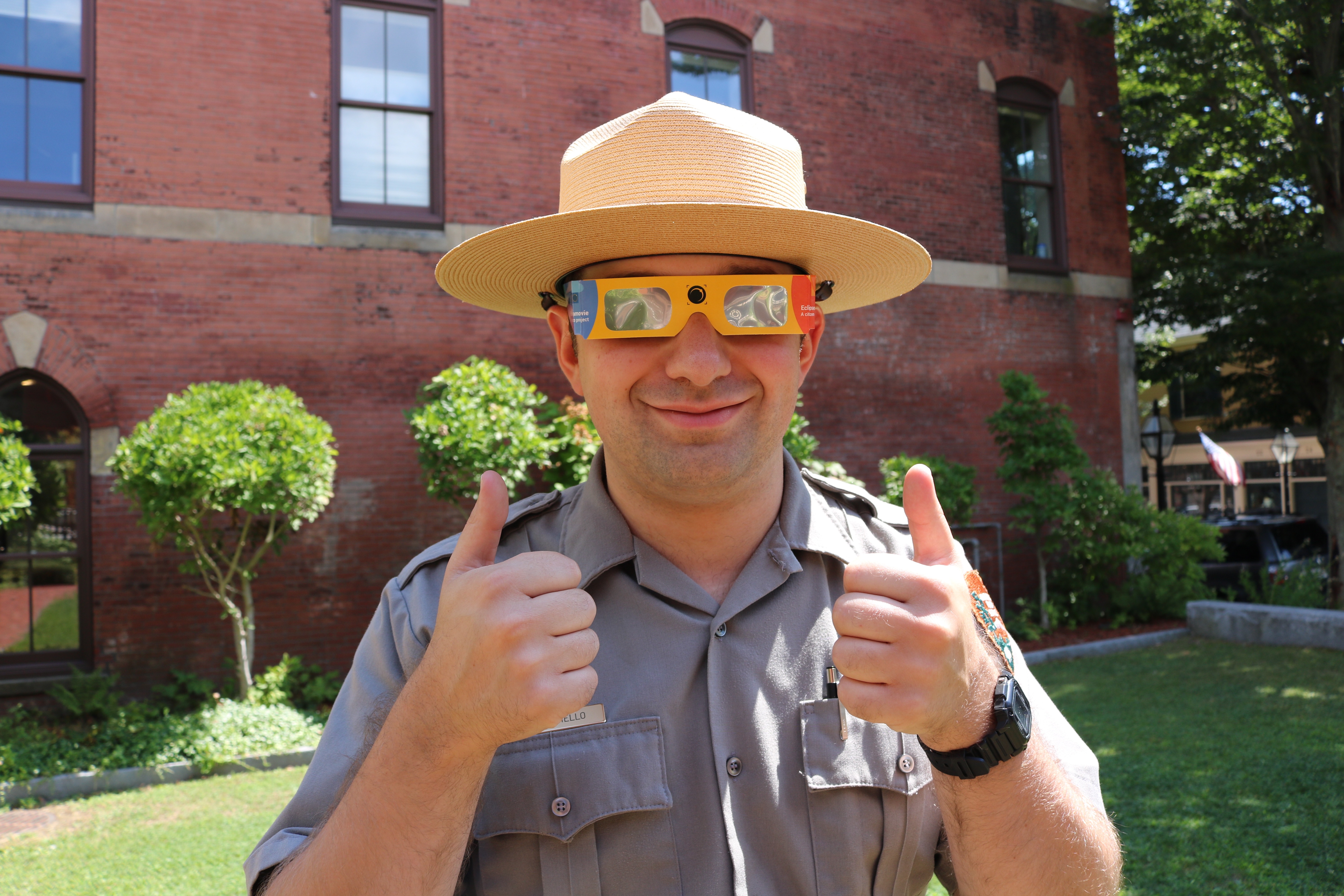 ranger wearing special glasses to view the eclipse