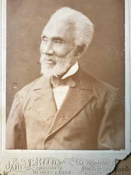 turn of the century photograph of an elderly, well-dressed black man