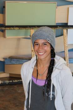 young smiling woman, standing in art studio