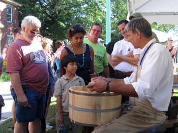 cooper, or barrelmaker, creating a barrel by hand