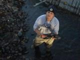 A man standing in a river holding a fish. A man standing in a river holding a fish.