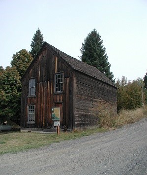 A two story building with wood paneling on the outside.