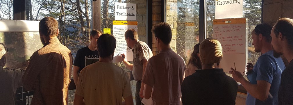 people engaged in a meeting in a park visitor center