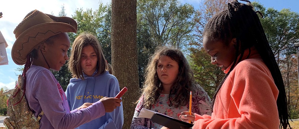 girls with anemometer and notepad