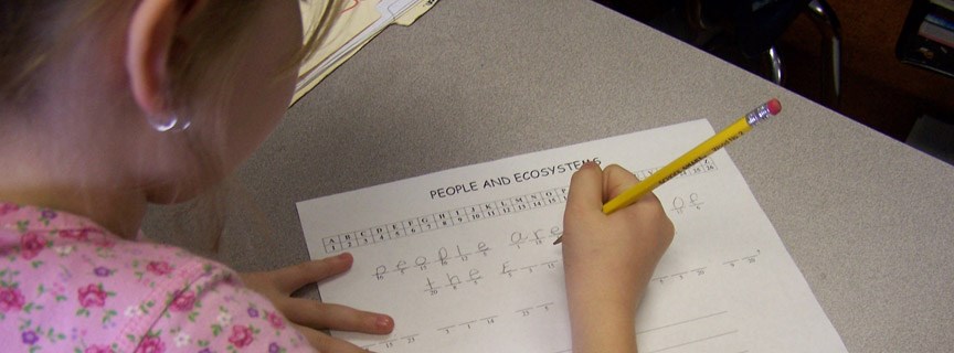 student writing on worksheet