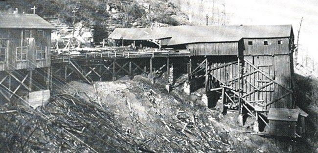 A large wooden building built into the side of a steep gorge