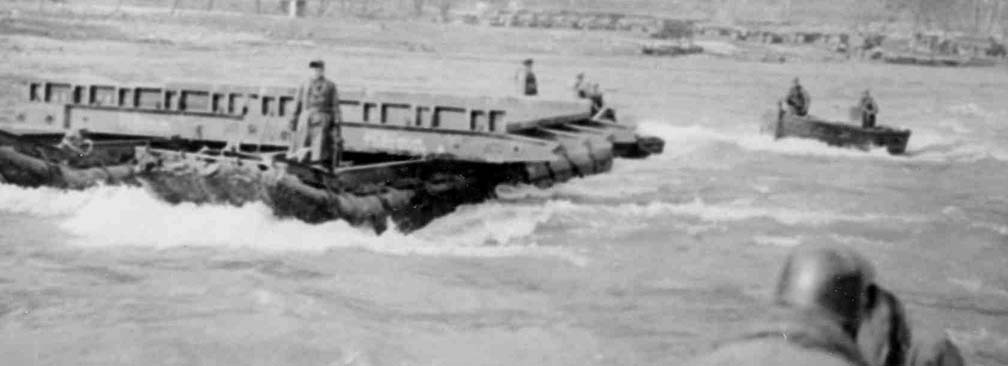 historic photo of soldiers building a bridge across river
