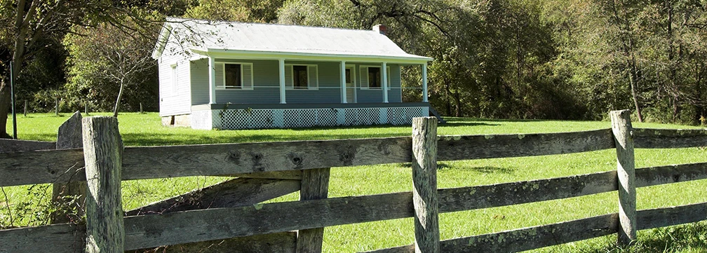 farmhouse behind split rail fence farmhouse behind split rail fence