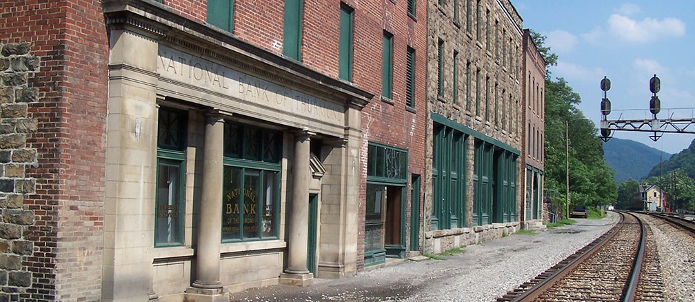 Brick store fronts of Thurmond's commercial row in front railroad tracks