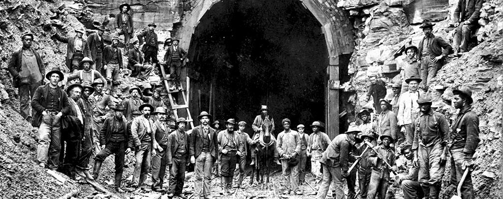 historic photo of workers in front of RR tunnel